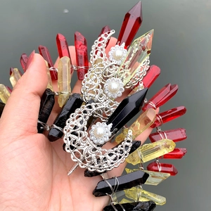 Detailed close-up of handmade crystal crown with wire-wrapped red and yellow quartz