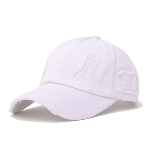 Detailed close-up of distressed white twill cotton baseball cap with ripped holes