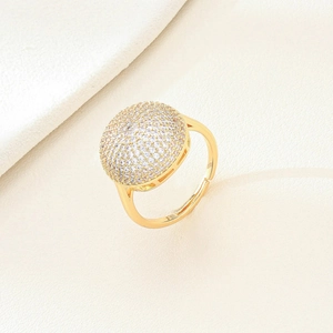 Chic gold plated adjustable ring featuring a round face pavé set with sparkling zircons