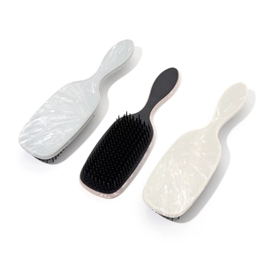 Three professional marble patterned air cushion massage hairbrushes in various colors