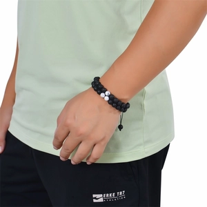 Detail of adjustable double-layer matte tiger eye and lava stone bracelet on wrist
