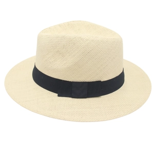 Detail of woven Panama straw hat featuring a classic black grosgrain ribbon and flat bow