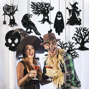 Detail of black glitter Halloween silhouette decorations featuring raven and spider web