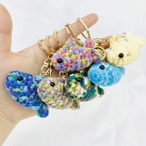 Handcrafted crochet fish keychains in vibrant colors with gold metal hooks and rings