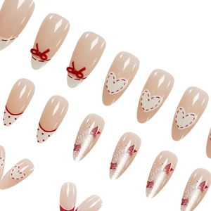 Red bow press-on nails with heart patterns, polka dots and silver cat-eye star details