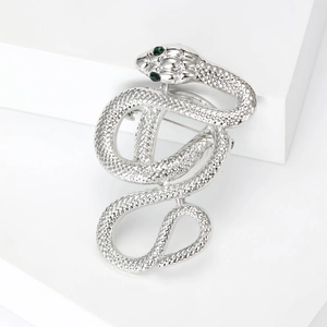 Creative silver snake brooch with textured scales and green gemstone eyes for coats