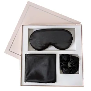 Three-piece black satin sleep gift set with eye mask and scrunchie in pink box
