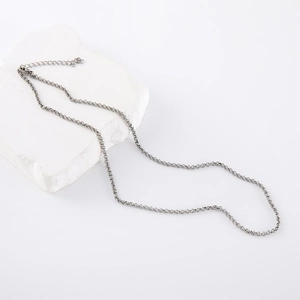 Minimalist silver stainless steel round pearl necklace with lobster clasp on white stone
