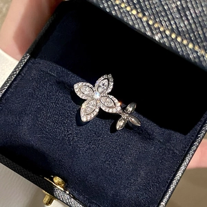 Macro shot of silver flower ring with marquise cut zircon on dark blue velvet