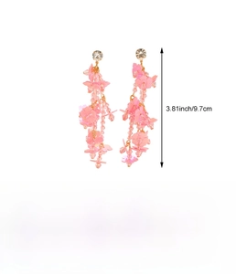 Detail view showing 9.7cm length measurement for pink acrylic flower tassel earrings