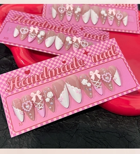 Three sets of handmade camellia press-on nails with pink and white heart bow details