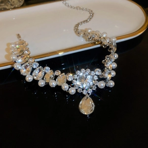 Close-up of pearl flower necklace featuring sparkling rhinestones and elegant white pearls