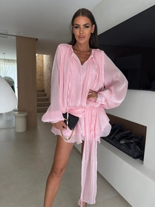 Detail of pink chiffon dress featuring lantern sleeves and pleated waist ties