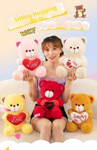 Detail of five assorted colorful plush teddy bears with embroidered love hearts