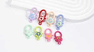 Flat lay of colorful flower-shaped alloy spring clasps for DIY jewelry making accessories