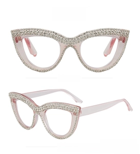 Detailed front and side view of cat-eye glasses with pink frame and inlaid rhinestones