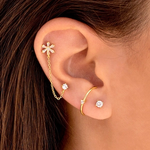 Elegant gold flower stud earrings set with sparkling zircon stones for double piercings