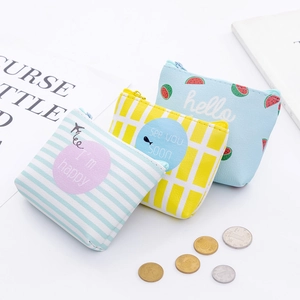 Detailed view of three mini PU leather coin purses with colorful patterns and top zippers