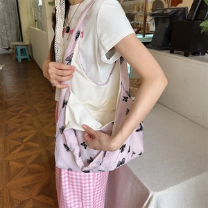 Pink tote bag detail showing internal zipper pocket and spacious beige inner lining