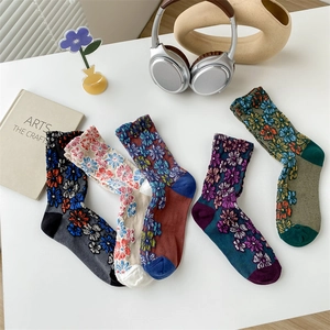 Flat lay of five vintage floral embroidery cotton socks in various retro color combinations