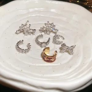 Elegant 7-piece set of zircon bow ear cuffs and pearl clip-on earrings in cream tray