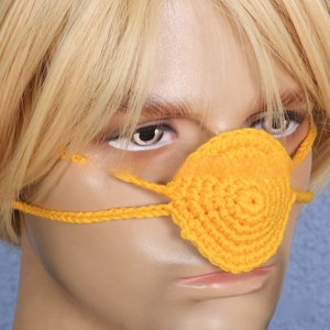 Detailed close-up of handmade bright yellow crochet nose warmer with ear loops for winter