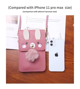 Compact pink rabbit ear phone bag compared with a mobile phone on a wooden surface