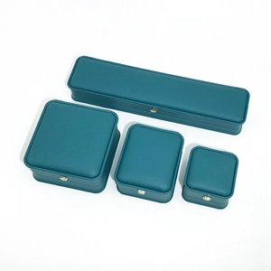 Detail view of four-piece dark green PU leather jewelry boxes with gold metal buckles
