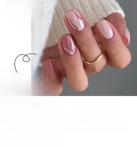 Close-up detail of short square press-on nails with pink marble and glitter designs
