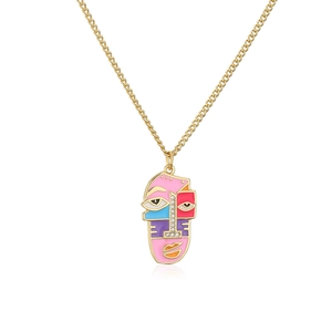 Detailed view of 18K gold-plated pendant featuring colorful enamel abstract face and crystals
