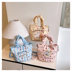 Detailed view of canvas bucket bags with cartoon animal prints and ruffled handles