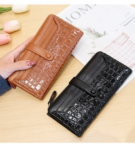 Detail of brown and black long wallets featuring crocodile pattern leather and snap closure