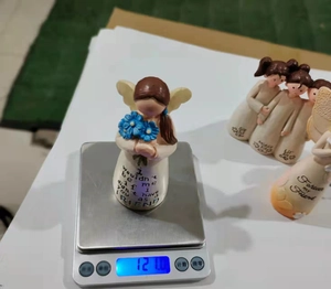 Detail of angel girl resin figurine with blue bouquet and friendship poem engraving