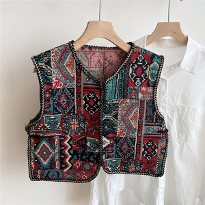 Detailed view of ethnic jacquard pattern and texture on embroidered vest shawl