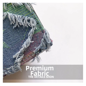 Macro shot of blue and green woven textured fabric with fringe edge for small square bags