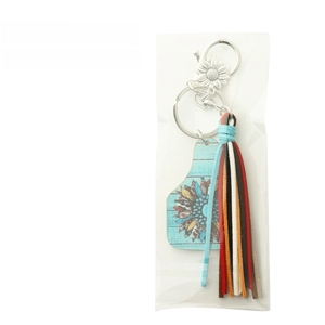 Detail of western cowhide tassel keychain with sunflower charm and blue wooden plate