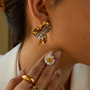 Artistic gold and silver dual-tone flower stud earrings with pleated metal texture