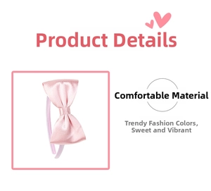 Close-up of a pink satin bow headband featuring glossy fabric and handmade 3D design