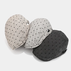 Three minimalist heart pattern beret caps in dark grey, medium grey and light beige colors