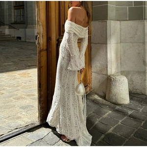Detailed view of white off-shoulder lace maxi dress with elegant vintage bell sleeves
