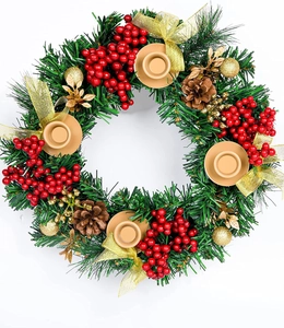 Top view of Christmas wreath with red berries, pine cones, and 4 gold candle holders