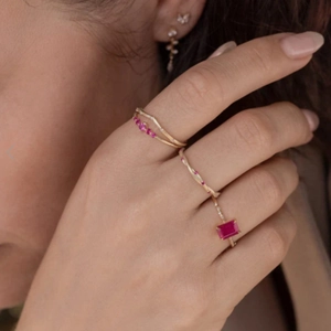 Close-up of gold-plated S925 silver rings with red gemstones in stacked style