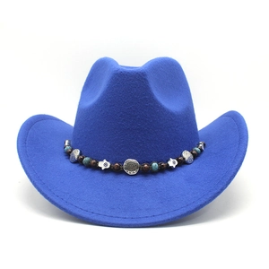 Detail of royal blue felt cowboy hat with bohemian turquoise beads and ethnic charms