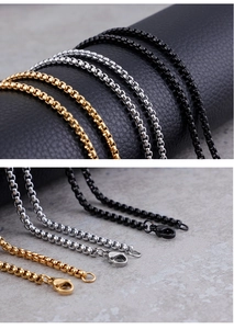 Detail view of square box chains in gold, silver, and black with lobster clasp closure