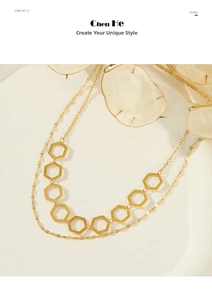 Detail view of a gold double-layer necklace featuring hollow hexagonal geometric pendants