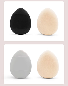 Detailed view of four teardrop mini finger puffs in black beige and grey soft textures