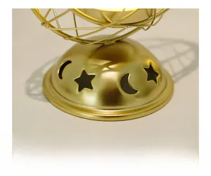 Macro view of gold metal incense burner base with star and moon hollow patterns