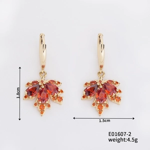 Detail showing dimensions of golden maple leaf earrings with orange teardrop gemstones