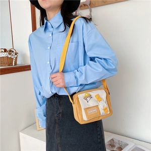 Adjustable yellow strap and contrast color details of the canvas crossbody bag