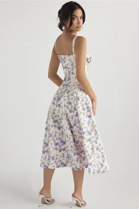 Detailed back view of white floral summer midi dress with blue flowers and strappy design